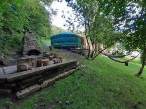 a train is parked in a field next to a park at Oakdean Cottage Yurt in Blakeney