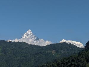 a snow covered mountain on top of a hill at The Mountain House in Pokhara