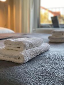 a pile of towels sitting on top of a bed at Apartment Poprad in Poprad