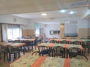 una sala vacía con mesas y sillas y un aula en Hotel Avellino, en Mar del Plata