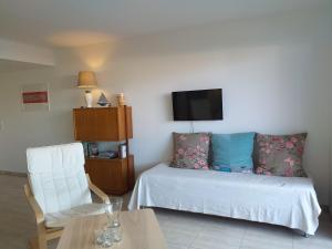 a room with a bed and a chair and a tv at Appartement B16 onde Marine in Port-Vendres