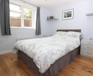 a bedroom with a large bed and a window at Beautiful Modern Apartment in Bath in Bath