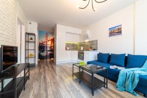 Televízia a/alebo spoločenská miestnosť v ubytovaní Apartament Sobieskiego 2a Parking gratiss