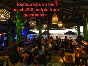 a group of people sitting at a bar at Prukrom Lanta Guesthouse in Ko Lanta
