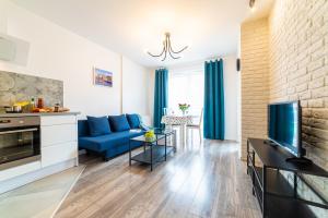 Televízia a/alebo spoločenská miestnosť v ubytovaní Apartament Sobieskiego 2a Parking gratiss