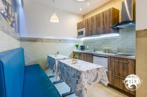 a kitchen with two tables and a sink at Maximus in Ustka