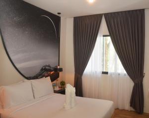 Postel nebo postele na pokoji v ubytování De Luna Hotel Sri Petaling