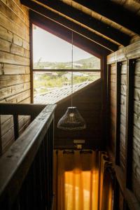 a chandelier hanging in a room with a window at Cabanas Mahalo in Imbituba +37 photos