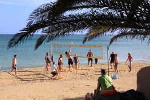 a group of people playing volleyball on the beach at Sotavento Beach Club in Costa Calma