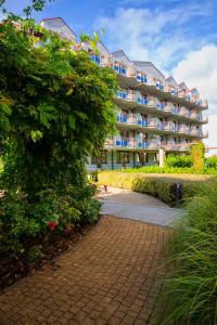 a large apartment building with a walkway in front of it at Wyspa Uznam - Wyspa Uznam in Świnoujście +25 photos
