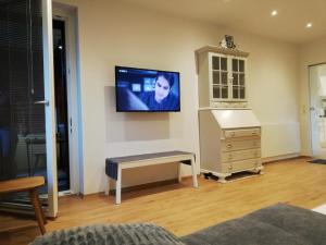 a living room with a tv on a wall at Ausseeerland in Bad Aussee