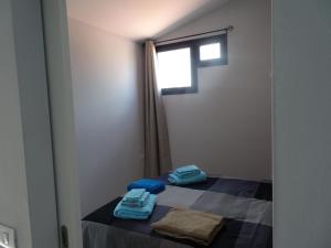 a room with a bed with blue towels on it at Appartamento Indipendente in Villa - Golf Del Sur in San Miguel de Abona +15 photos