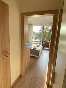a bedroom with a bed and a door to a balcony at Apartment Poprad in Poprad