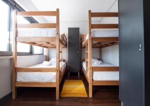 a room with bunk beds in a hostel at Villa Caparica Hostel in Costa da Caparica