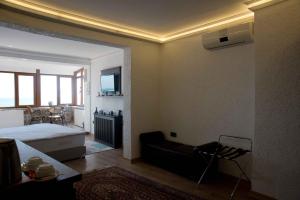 a bedroom with a bed and a couch in a room at Blue Tuana Hotel Old City in Istanbul