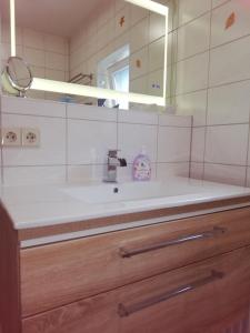 a bathroom with a sink and a mirror at Appartement Blaue Welle in Bansin