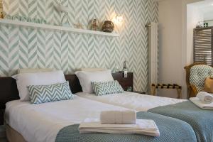 a bedroom with two beds with towels on them at CozyHome - Cabanas in Cabanas de Tavira +117 photos