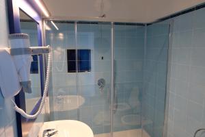 a bathroom with a shower with a toilet and a sink at Hotel Baia Di Puolo in Massa Lubrense