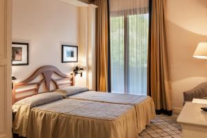 En eller flere senge i et værelse på Roccamare Resort - Casa di Levante