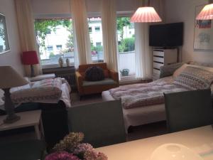 a living room with a couch and a tv at Ferienwohnung in Bonn in Bonn