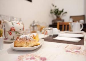 a pastry on a plate on a table at B&B Orchard in Viterbo