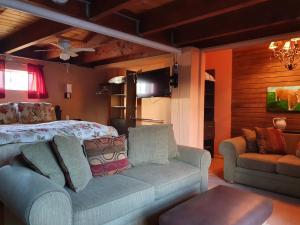 a living room with a couch and a bed at Hacienda Rancho Santini in Rosarito