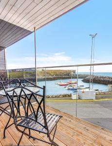 a porch with a bench and a view of the water at Hotel Duus by Keflavik Airport in Keflavík