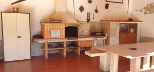 a kitchen with a stove top oven in a room at Casa grande Covelinhas in Covelinhas