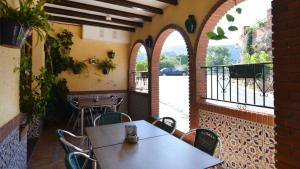 a dining room with a table and chairs in front of a building at La Posada del Conde in Ardales