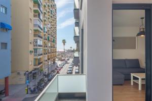 a view of a city street from a balcony at MalagaSuite Heart of Fuengirola in Fuengirola