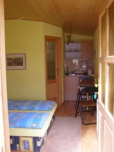 a small bedroom with a bed and a kitchen at Privát Liptov 11 in Liptovský Mikuláš