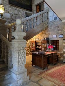 an office with a stone staircase and a desk at Hotel A Torre do Xudeu in Tui