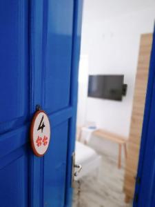 a blue door with a sign in a room at L'onda Oda Bodrum in Bodrum City