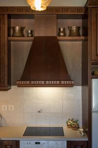 a hood over a stove in a kitchen at Xatheri Villas in Vamos