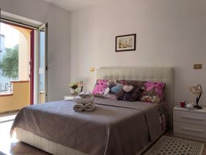 a bedroom with a bed with stuffed animals on it at Appartamento in Villa Andreina in Orosei