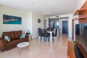 ein Wohnzimmer mit Couch und Tisch in der Unterkunft CH Oasis Sea Senses Punta Prima in Torrevieja