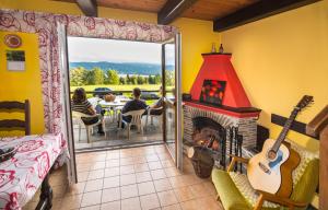 a room with a fireplace and people sitting at a table at Chata Hansenka in Lipno nad Vltavou