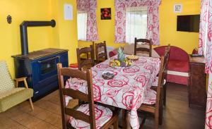 a dining room with a table and a stove at Chata Hansenka in Lipno nad Vltavou