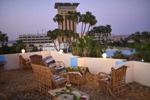 a group of chairs and a table and a building at Kosh royal house in Aswan
