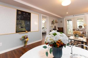 a living room with a vase of flowers on a table at Lily's garden in Charlottetown