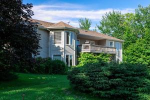 a house with a balcony on the side of it at Lily's garden in Charlottetown