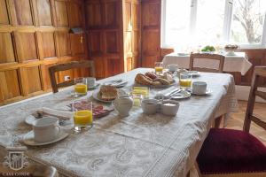 a table with a breakfast of bread and orange juice at Hotel Boutique Casa Conde in Santiago +37 photos