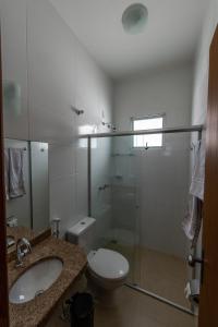 a bathroom with a toilet and a sink and a shower at Hospedaria Santo Antônio in Diamantina