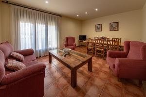 a living room with a table and a dining room at Casa El Sastre III in Beceite