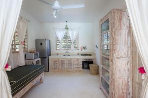 a kitchen with a refrigerator and a table in a room at Swordfish Villas in Malindi