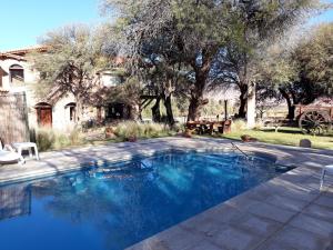
a pool with a pool table in front of a house at La Casa De La Bodega - Wine Boutique Hotel in Cafayate
