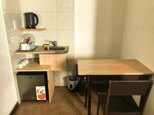 a small kitchen with a sink and a table at Hotel Messina in Mar del Plata
