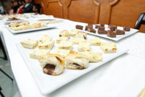 a white table with several different types of desserts at Relais De La Haute Ville Tana in Antananarivo