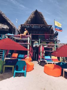 a group of chairs and umbrellas on a beach at Familia Vista al Mar - Baru in Barú