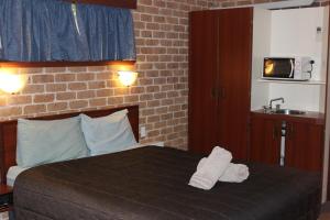 Säng eller sängar i ett rum på Acacia Motor Inn